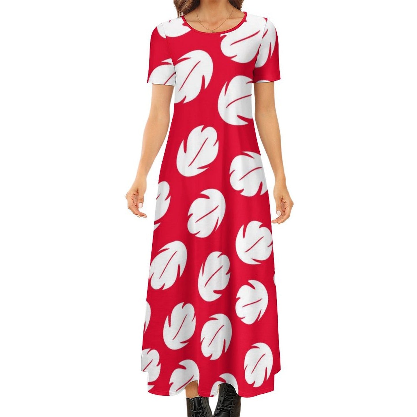 A woman wearing a red dress with white leaf patterns.