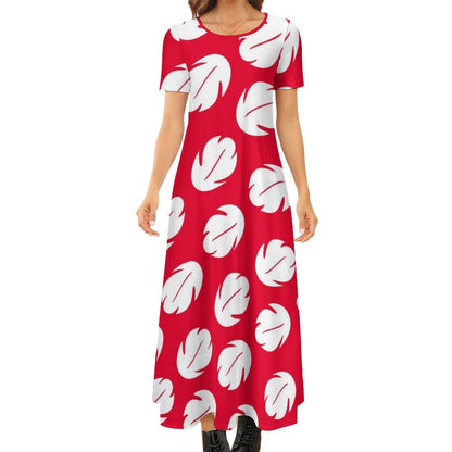 A woman wearing a red dress with white leaf patterns.